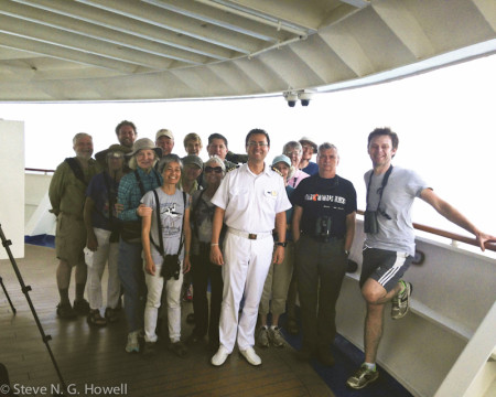 Our birding group often attracts some attention from the crew. In 2016 the captain even came by and graciously posed for a photo with the group.